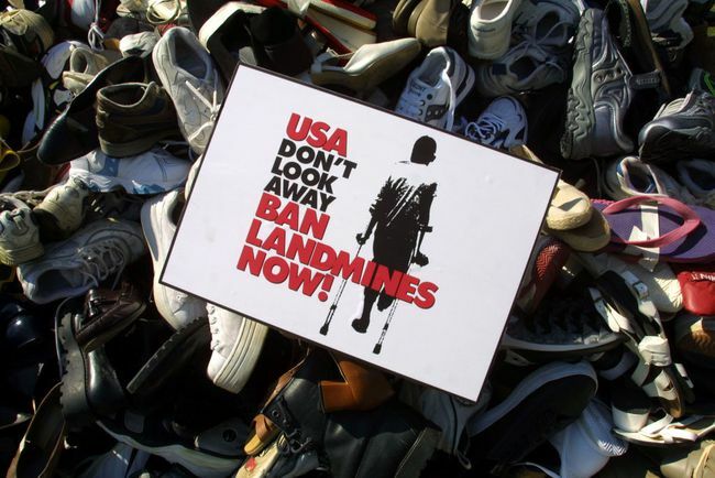 लैंडमाइंस पर प्रतिबंध लगाने के लिए यू.एस. अभियान द्वारा पिछले कुछ महीनों में एकत्र किए गए जूतों द्वारा ढेर किए गए पिरामिड पर एक प्रतिबंध बारूदी सुरंग का चिन्ह रखा गया है।
